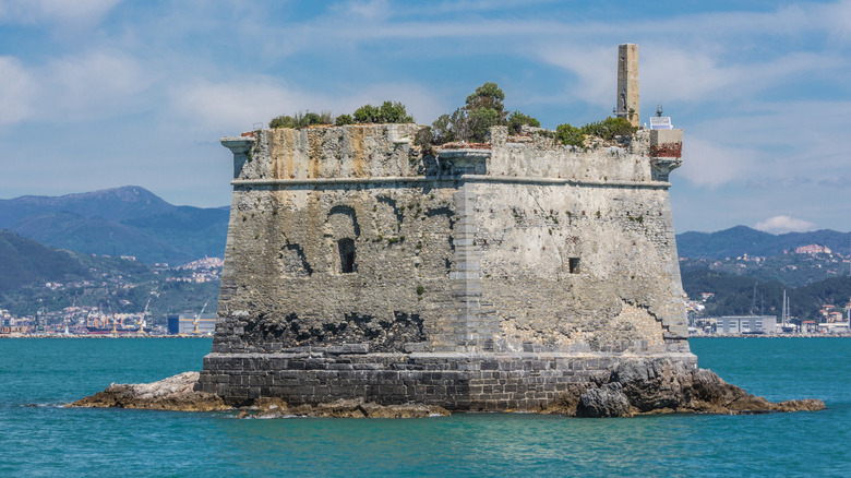 A stone tower in the middle of the sea