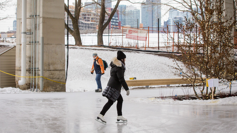 Ice skaters glide across the ice on the Bentway in Toronto