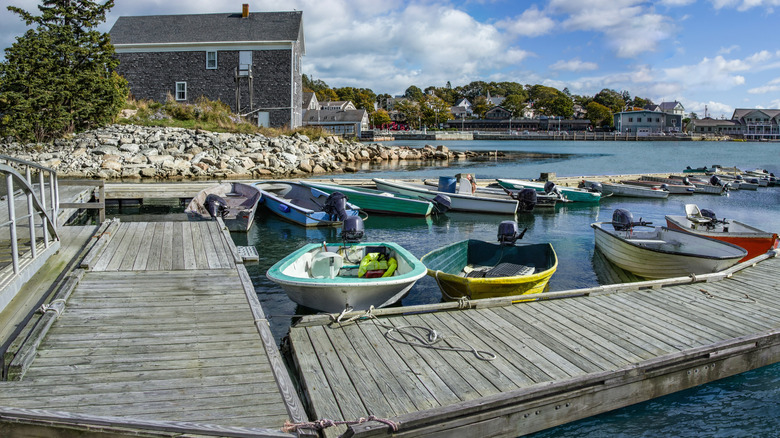 small boats tied up along wooden piers in Stonington harbor on Deer Isle in Maine