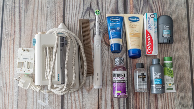 A flat lay photo of toiletries and electric toothbrush