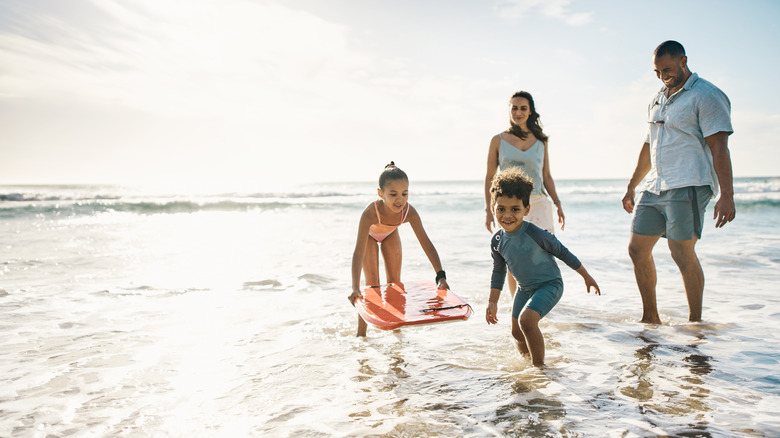 family playing in water