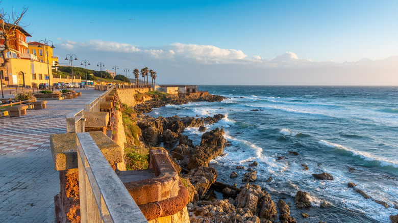 seaside promenade with ocean waters and rocky beach