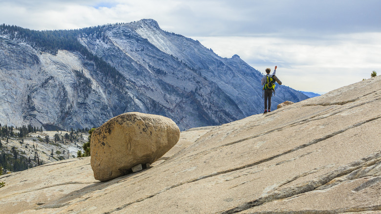 hiker walking on rock slab near Olmstead Point