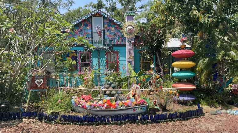 beads, jester masks, and colorful decorations among tropical plants