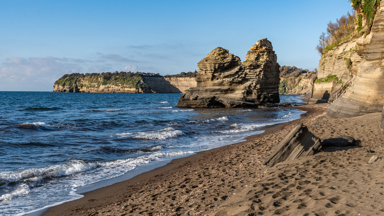 Sandy beach flanked by rocky cliffs