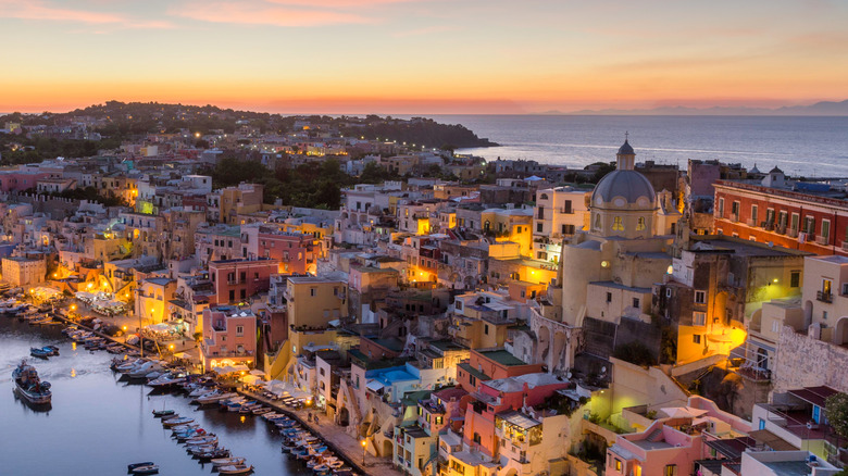 Sunset over the island with buildings lit up by lights