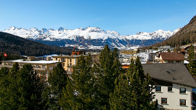 An idyllic Swiss village with snowcapped mountains
