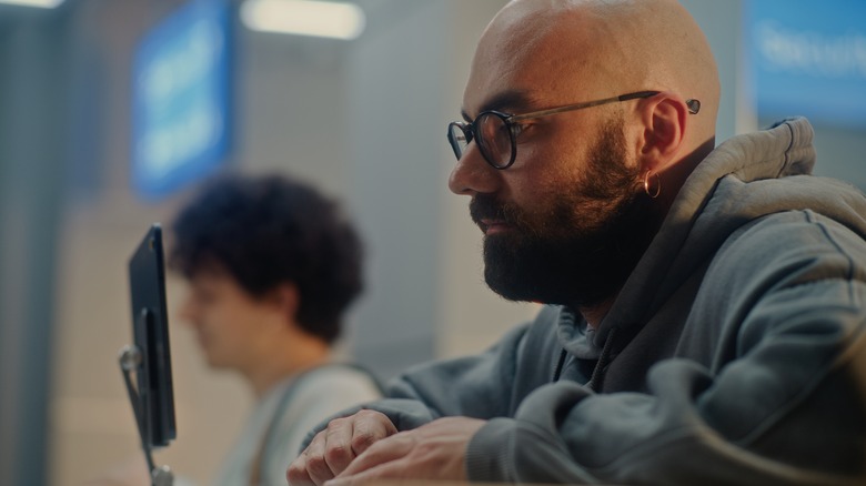 Man and teenager at airport passport control