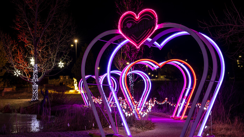 A tunnel of heart-shaped lights glowing at night