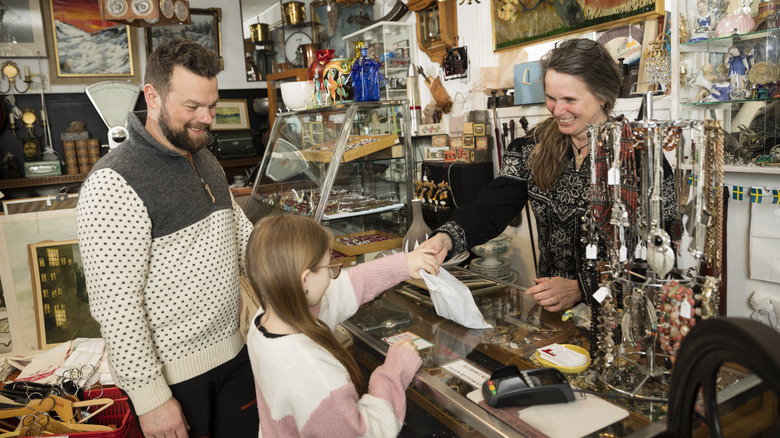 Father with daughter doing shopping in antique shop
