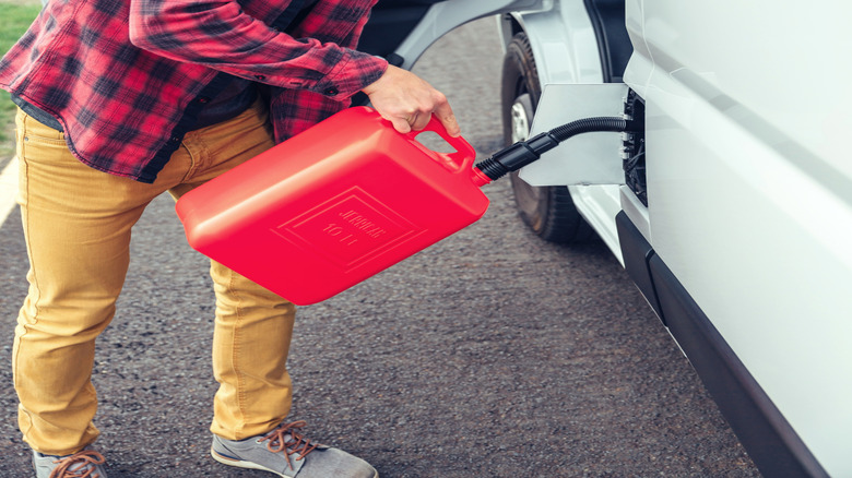 man refueling his camper van