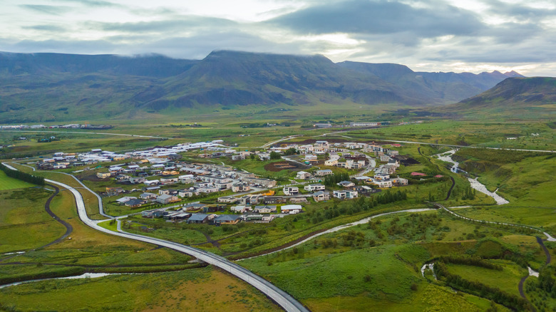 small town in green landscape with hilly backdrop