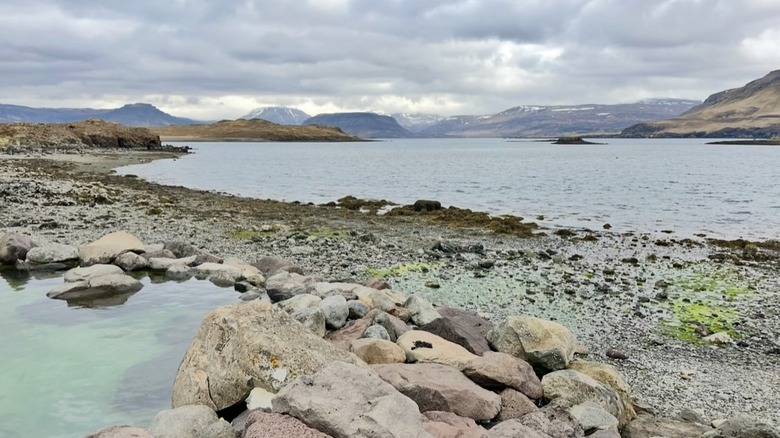 hot spring on rocky ocean shore