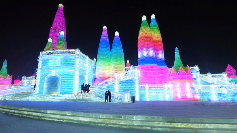 Visitors climbing the ice sculptures