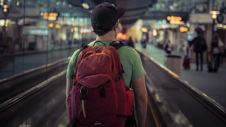 Man with backpack at airport
