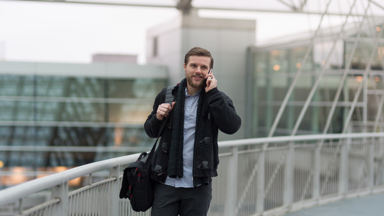 Man on the phone at the airport