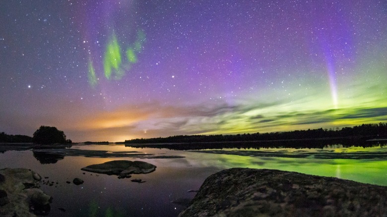 northern lights shining on lakes