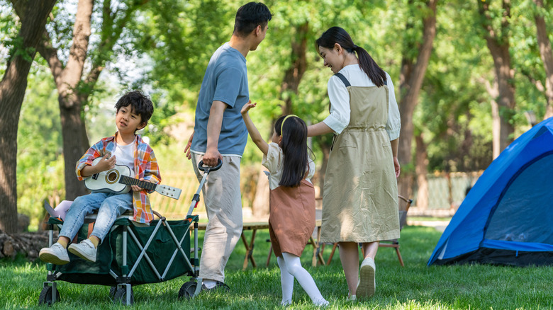family with wagon camping