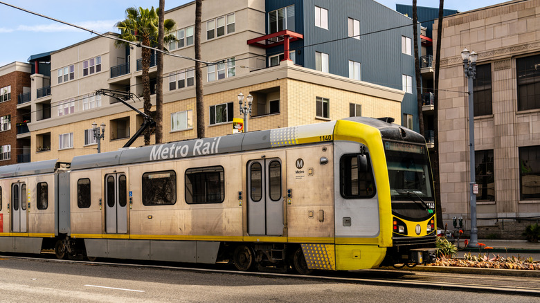 A light rail car runs down tracks in Los Angeles, California