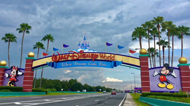 The Walt Disney World Entrance against a cloudy sky.