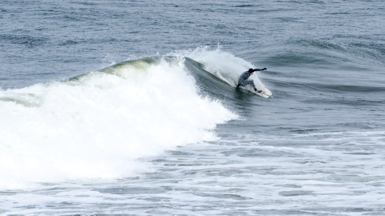 surfer surfing with full wetsuit