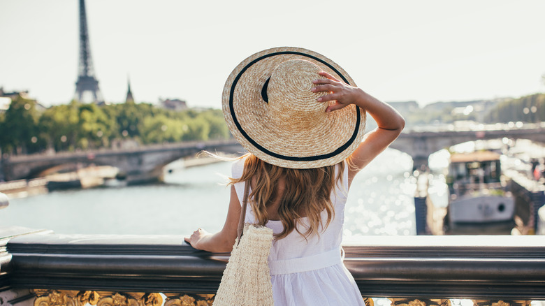 Woman looks at Eiffel Tower