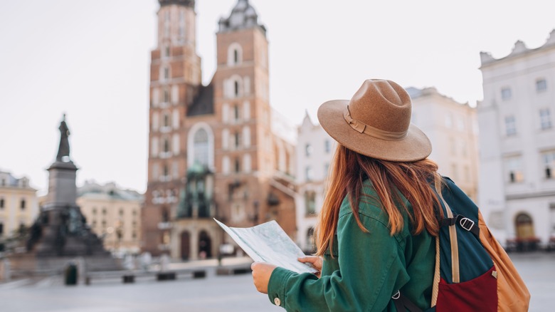 Traveler with map in piazza