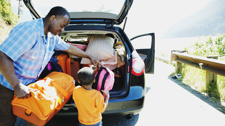 Family packing the car for a road trip 