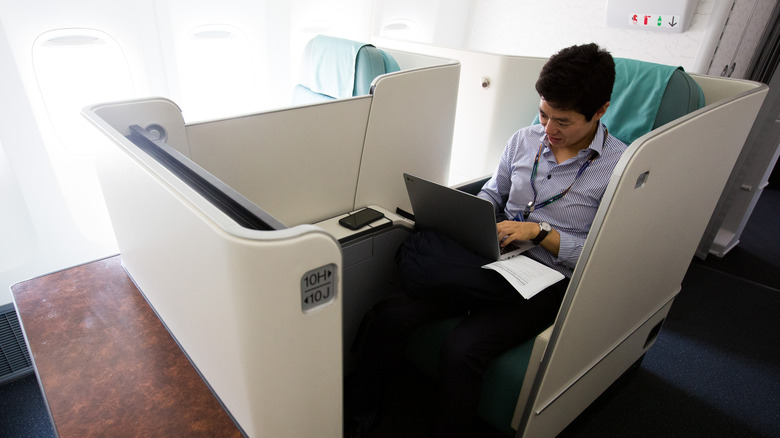 Man with laptop on plane