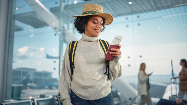 person with passport in airport