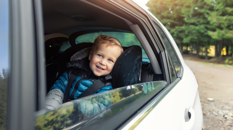toddler smiling out car window