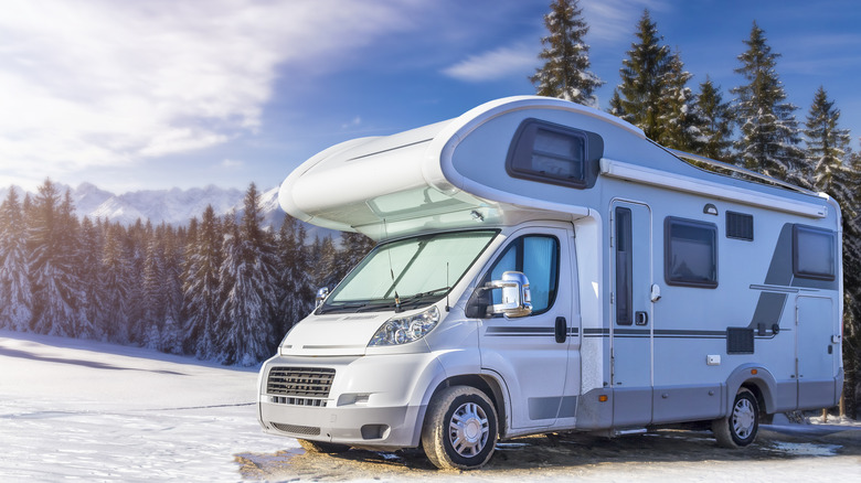 rv parked in snowy campsite