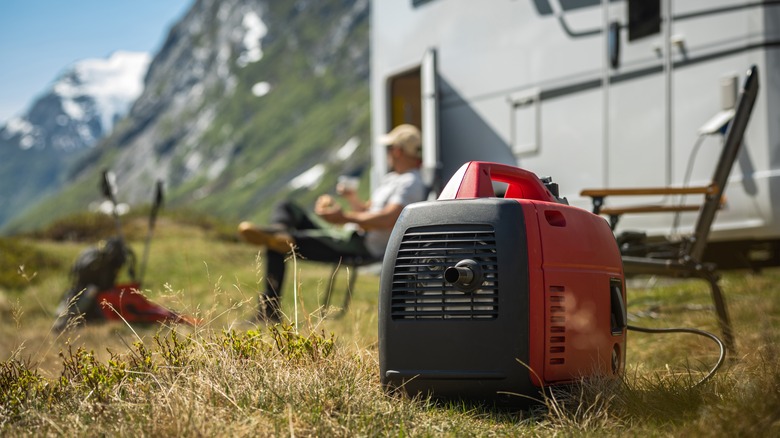 A generator stands next to an RV in the mountains