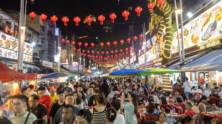 A crowded street scene of Jalan Alor a street food night market located in the Bukit Bintang area of Kuala Lumpur, Malaysia.