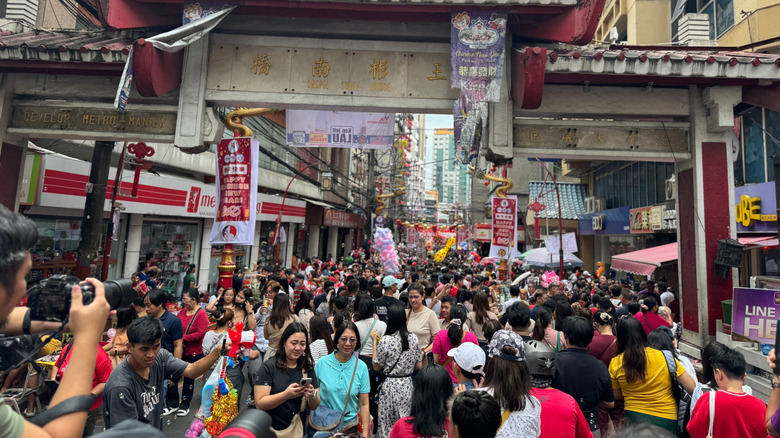 Manila, Philippines- a crowd of people in Binondo Chinatown celebrating Chinese New Year