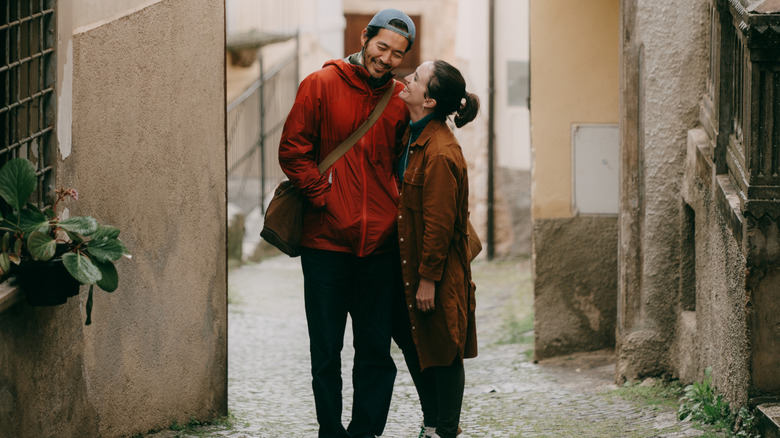 Tourist couple embracing on street