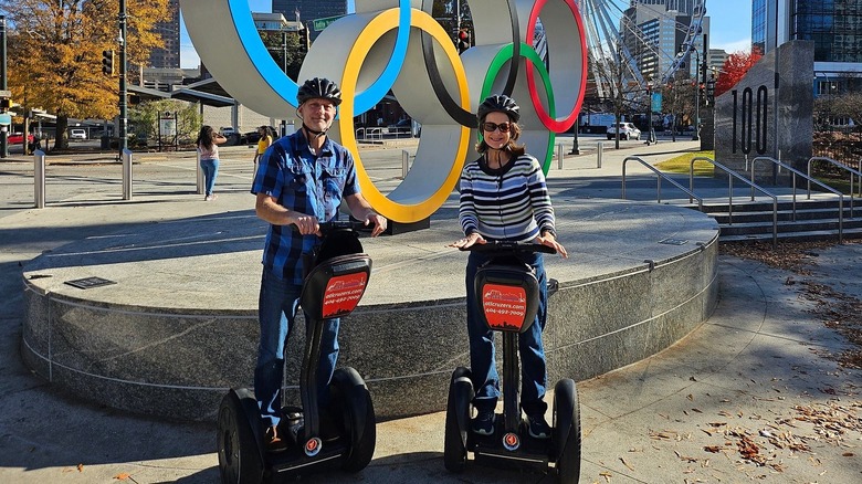 Two Segway riders in front of the Olympic rings in Centennial Olympic Park in Downtown Atlanta.