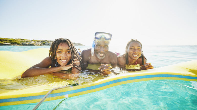 a father and two sons floating on the Caribbean Sea