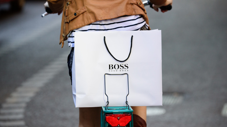 person cycling with hugo boss bag