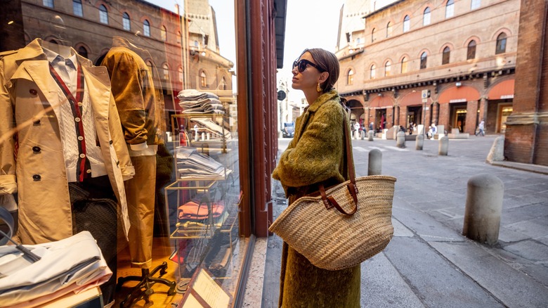 A stylish woman window shopping in the streets of Italy