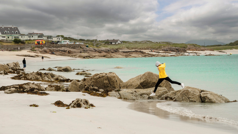 A person jumping on the beach in Ireland.