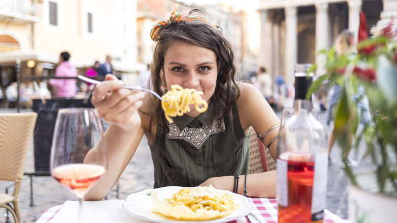 Person eating pasta in Rome