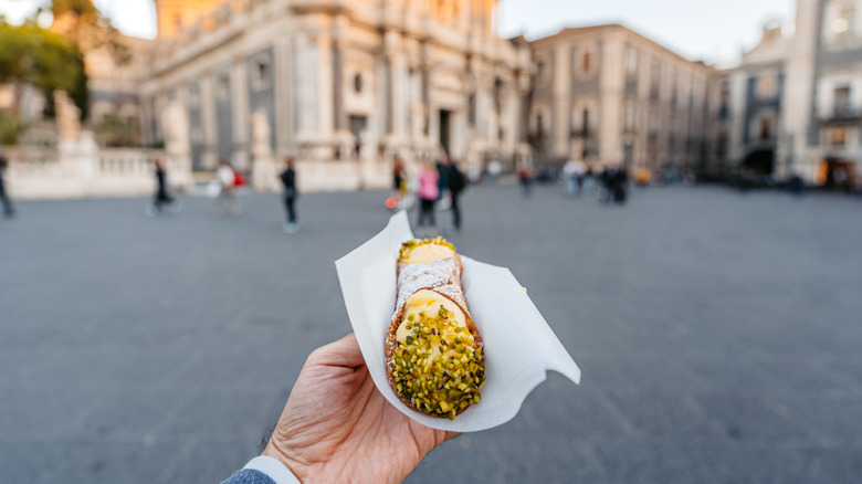 Hand holding canollo in Catania