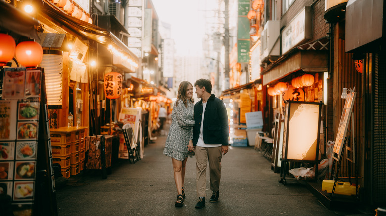 Couple walking in alley in Tokyo