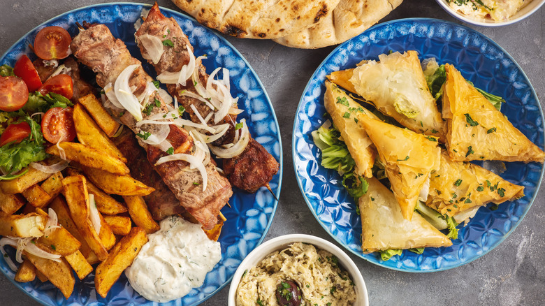 Bird's eye view of several plates of Greek food