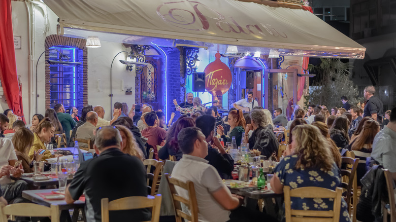 Busy outdoor restaurant with a band playing