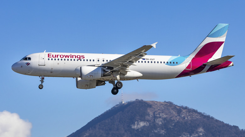 Eurowings airplane flying over a hill