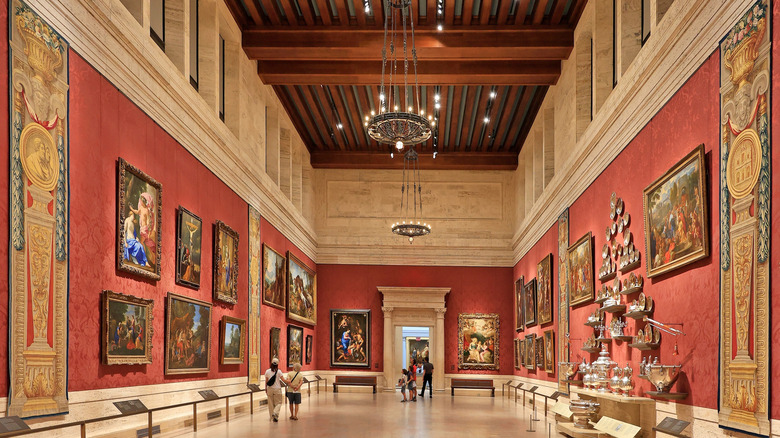 Visitors walking around a large museum room