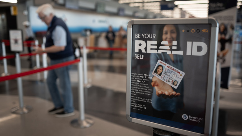 A Real ID sign next to an airport checkin line.