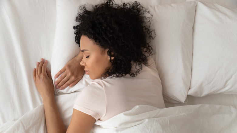 Woman asleep in comfortable bed